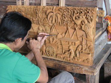Artist carving wood picture